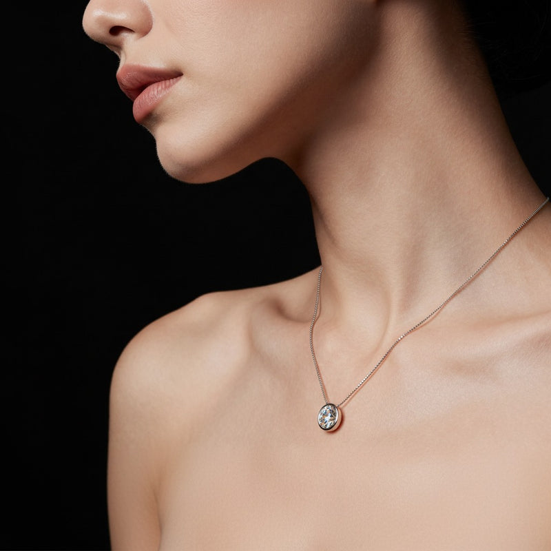 Model wearing round solitaire pendant