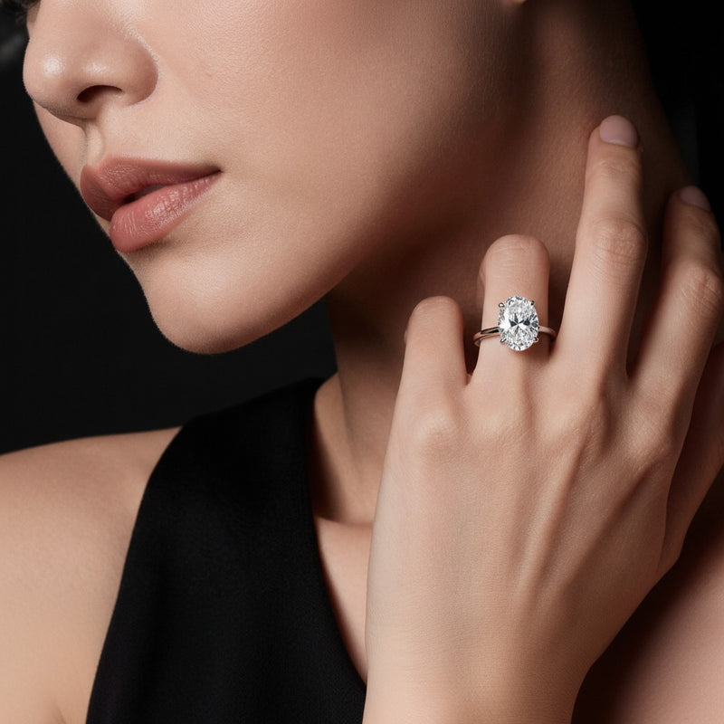 Model wearing oval lab grown diamond classic solitaire ring