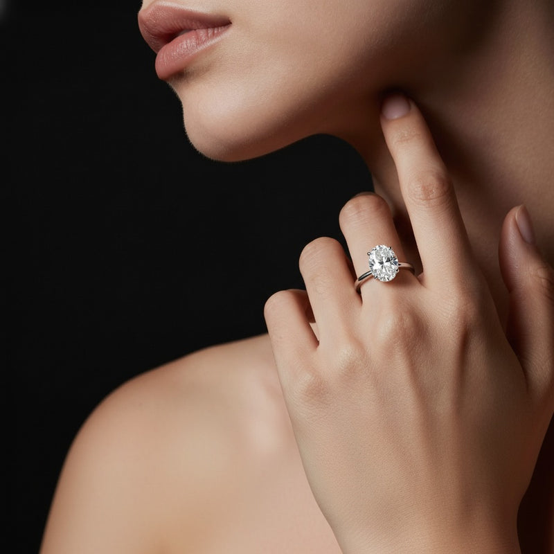 Model wearing oval lab grown diamond classic solitaire ring