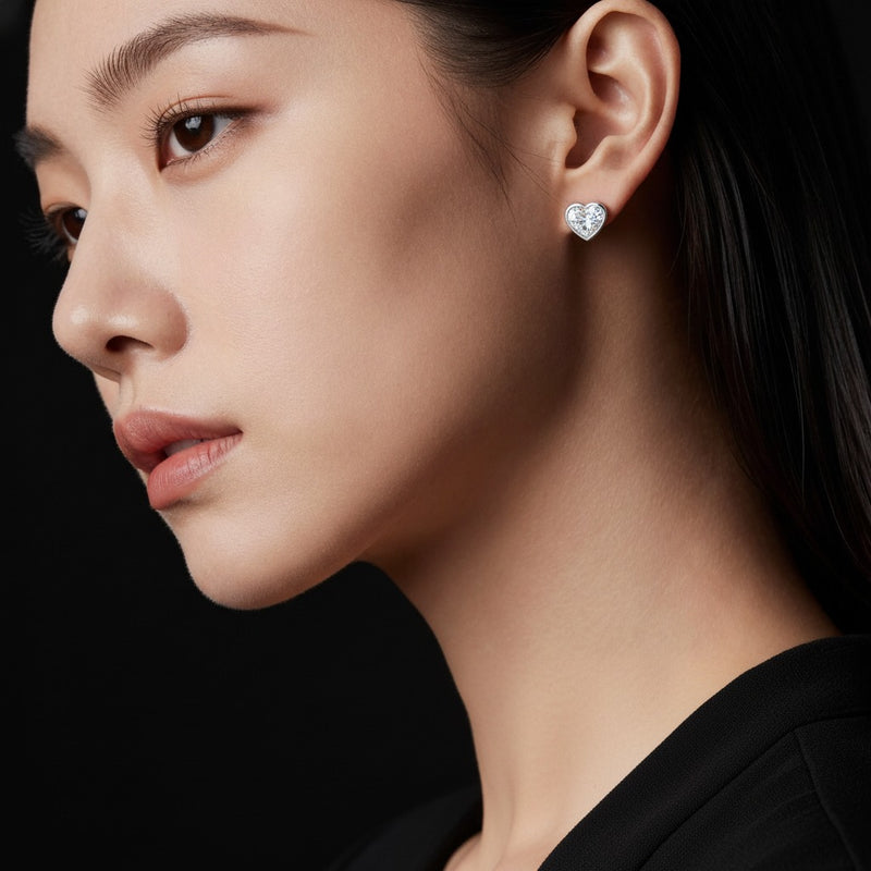 Model wearing heart bezel set stud earrings