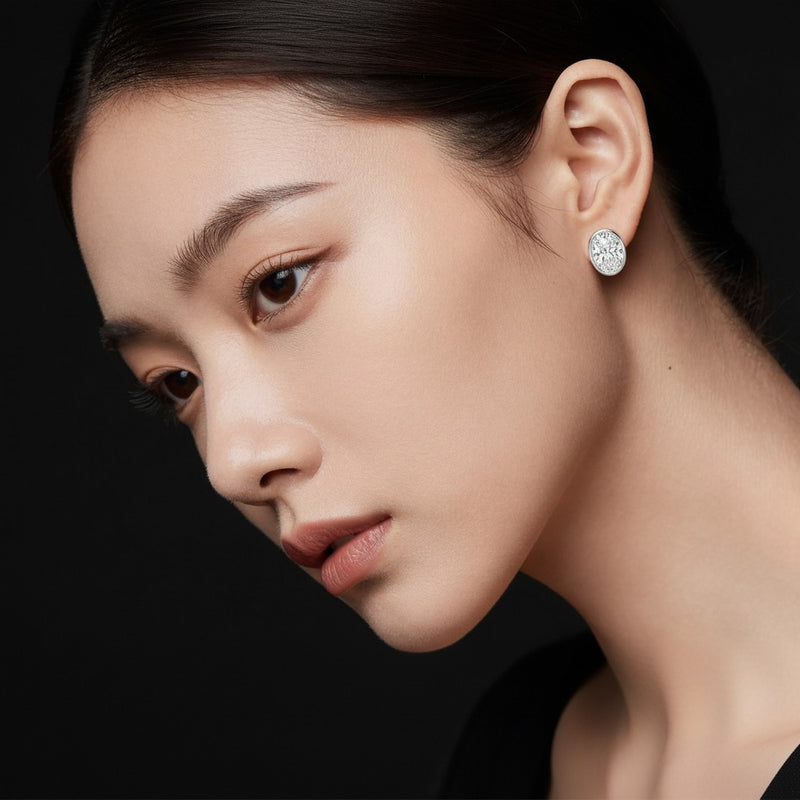 Model wearing oval bezel set stud earrings