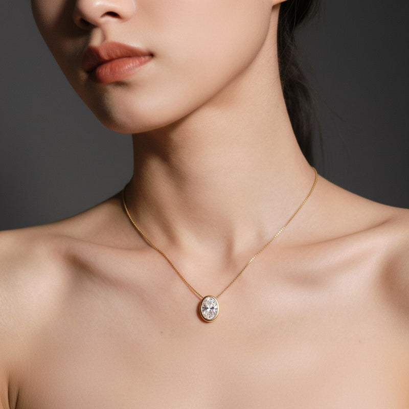 Model wearing oval bezel set solitaire pendant