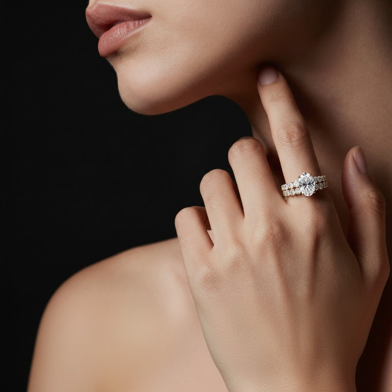 Model wearing oval bridal set with matching band and ring