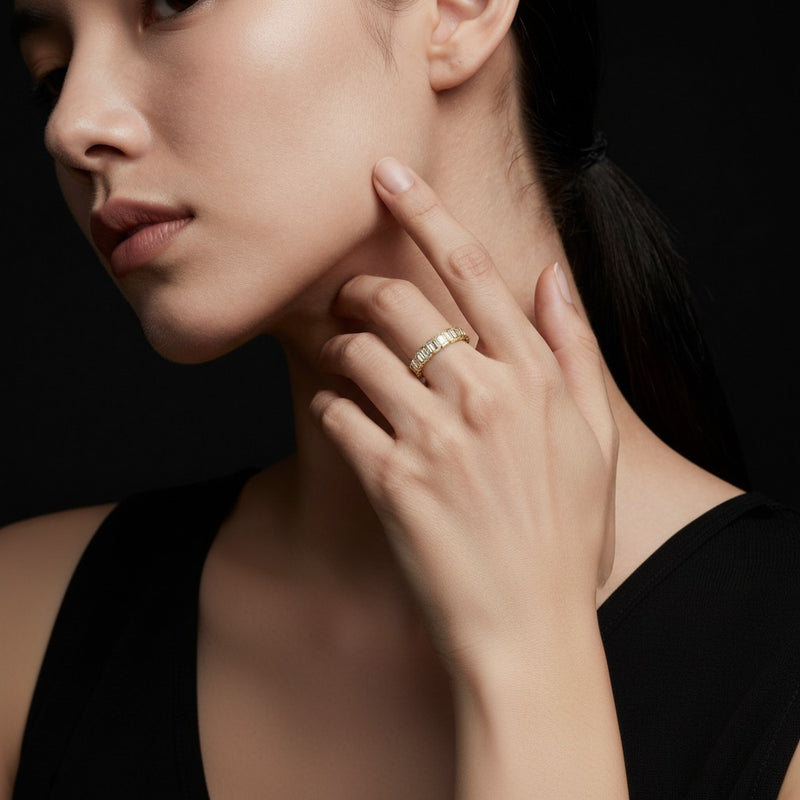 Model wearing emerald eternity band ring